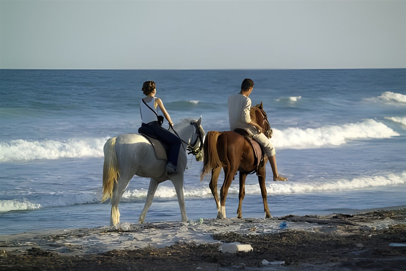 People riding horses on the sandy beach at Paternoster
