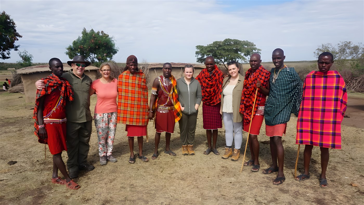 Guests with Masai warriors in the Masai Mara