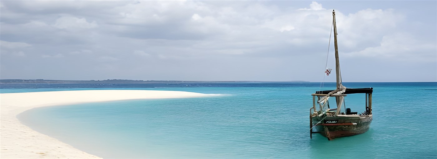 Dhow on the water beside a beautiful beach in Zanzibar