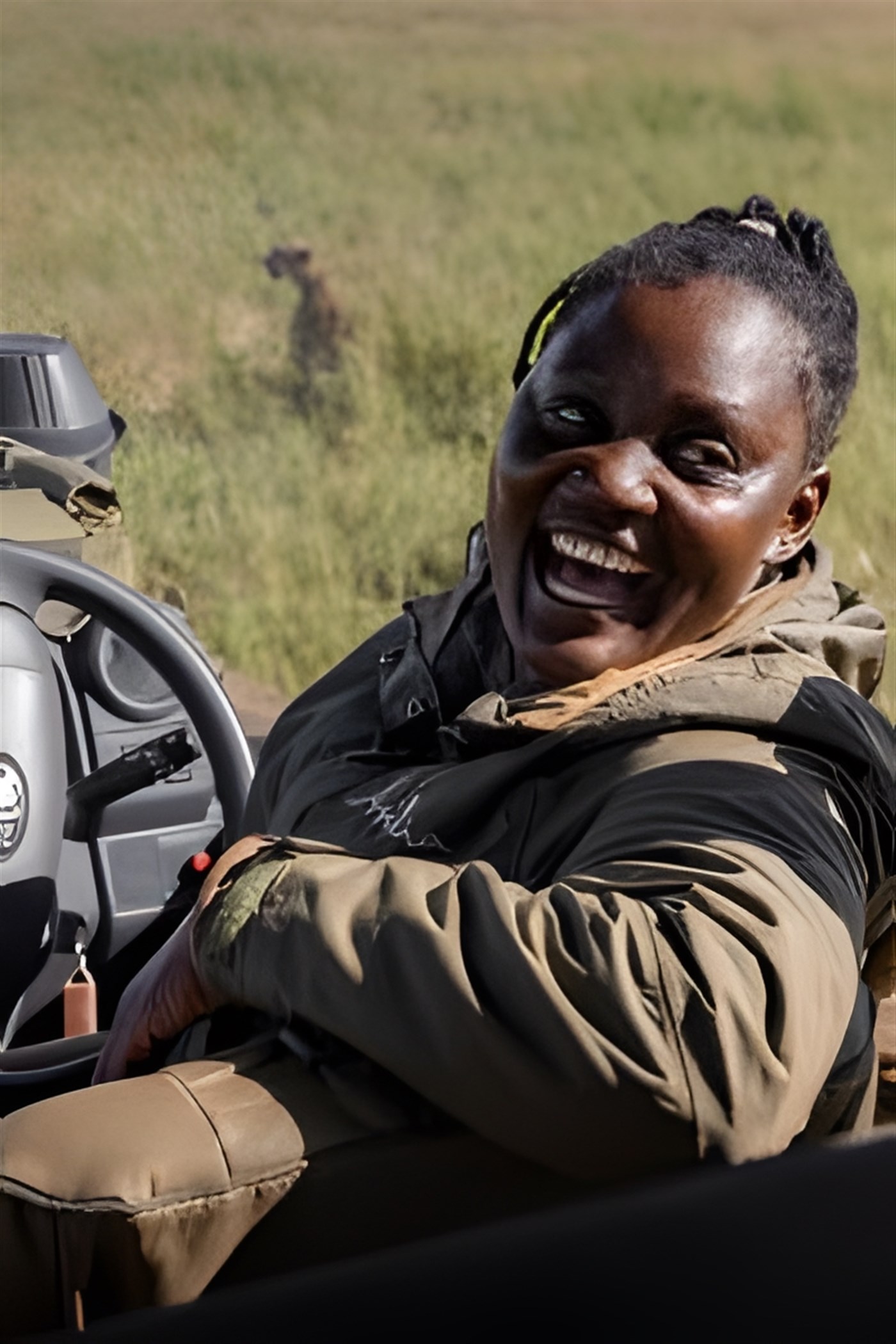 Woman sadari guide in a safari vehicle with an animal in the background