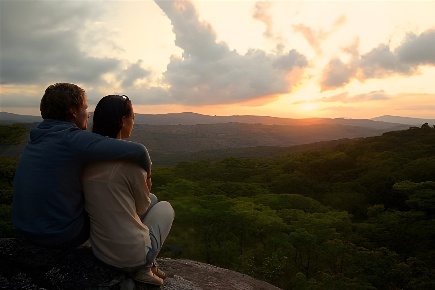 Couple looking over a romantic sunset in Africa