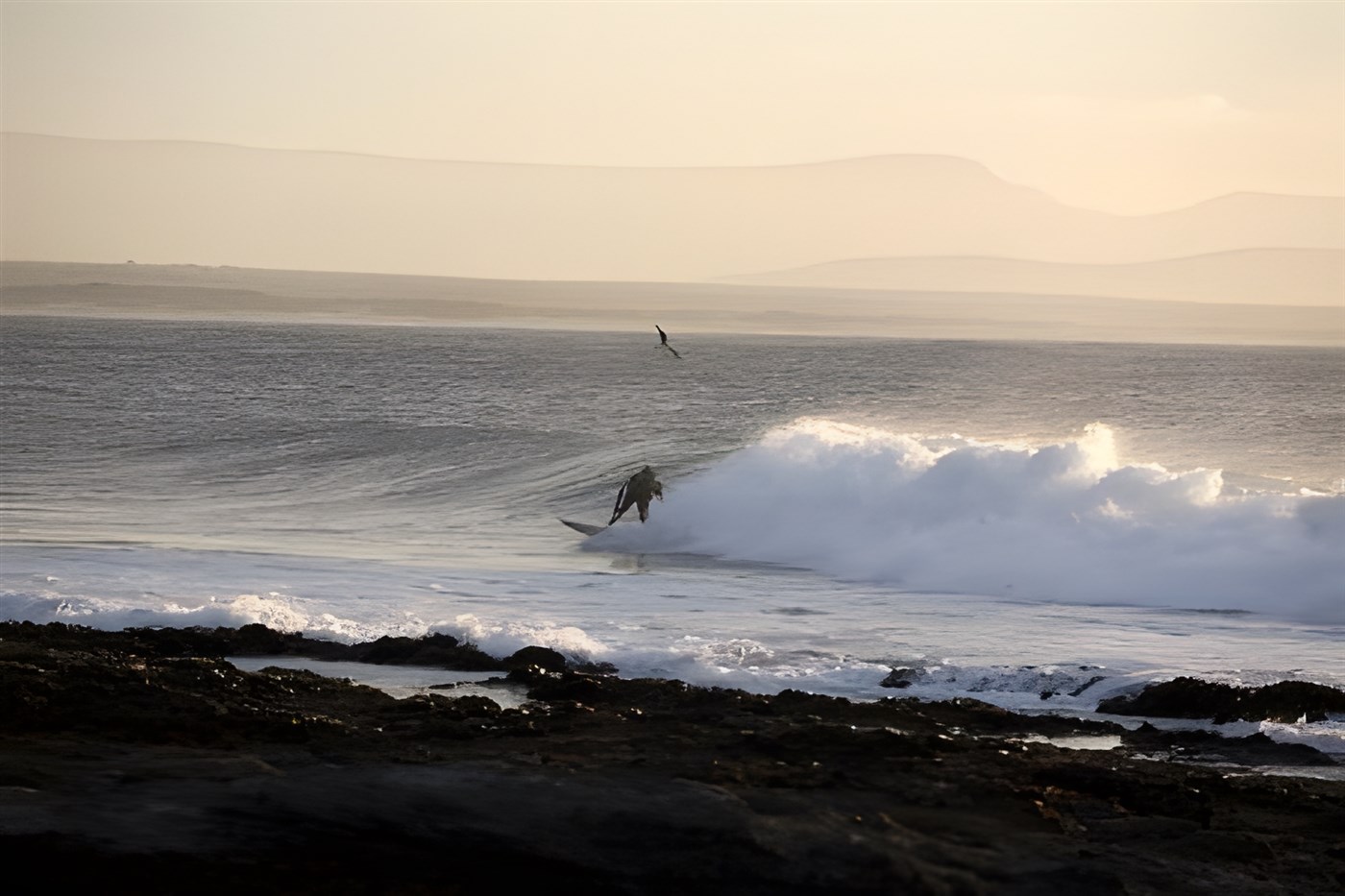 Surfer riding a wave at Jeffrey's Bay, a famous surfing beach in South Africa