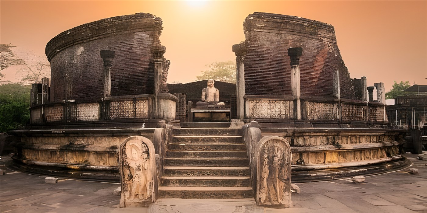 Ancient stone ruins of the Polonnaruwa Vatadage in Sri Lanka, featuring intricately carved guardstones, a stairway with ornate detailing, and a seated Buddha statue at the center under a bright blue sky. This UNESCO World Heritage Site showcases the island’s remarkable heritage and ancient Buddhist architecture.