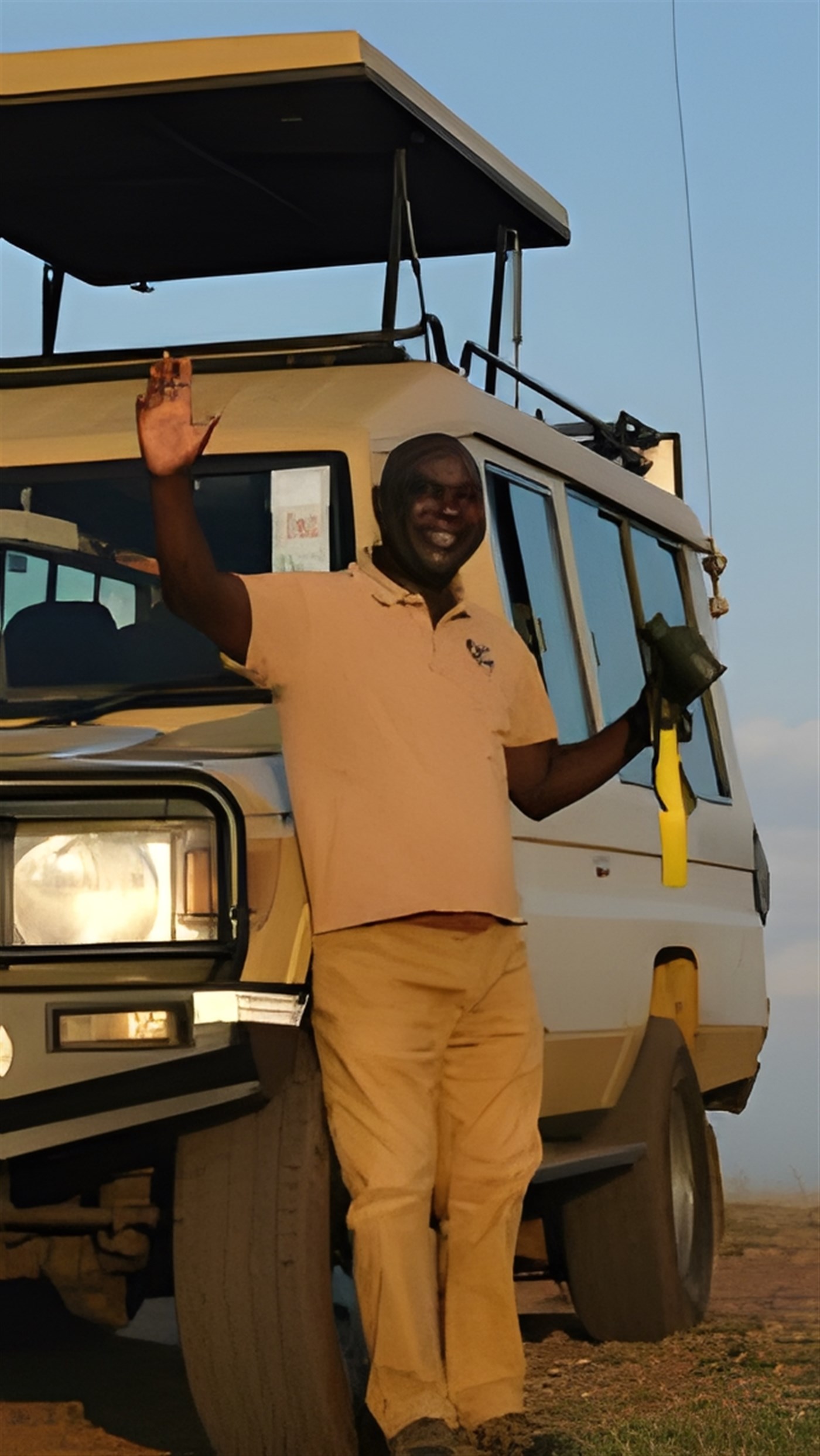 Driver Guide standing in front of a Safari Vehicle.